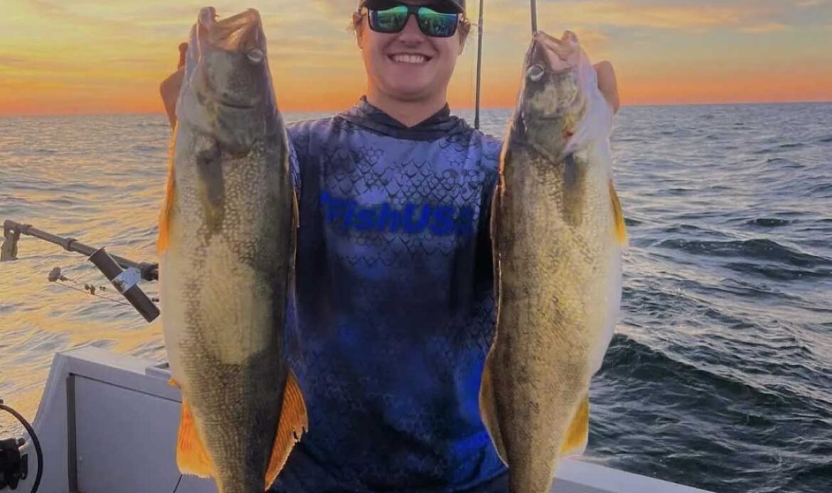 An angler shows two large Walleye caught on Lake Erie
